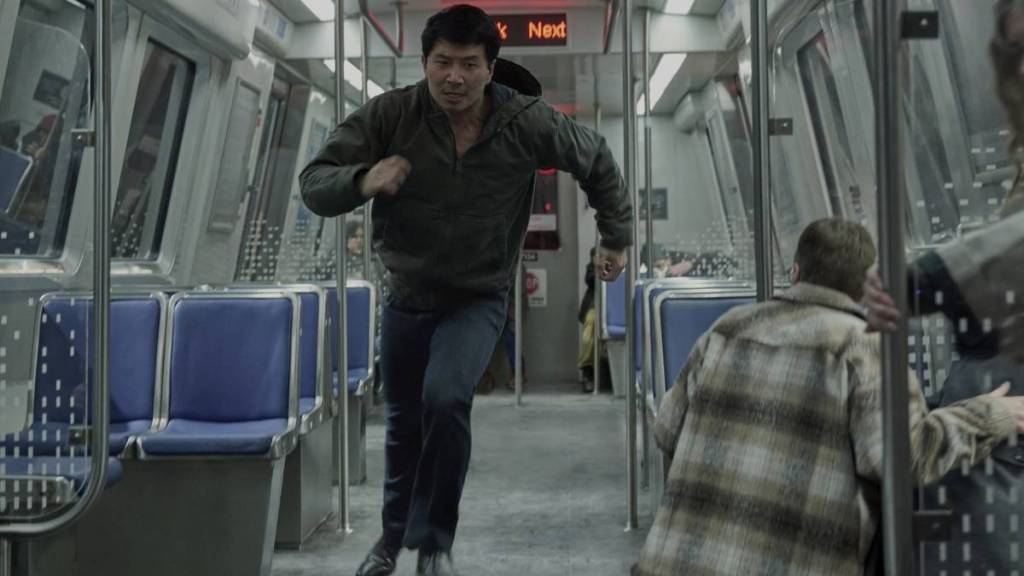Simu Liu running on a train in The Copenhagen Test. Image Credit: Peacock